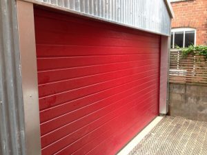 Alutech Small Rib insulated sectional garage door in Red RAL colour