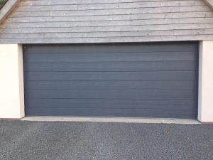 Carteck Medium Rib insulated sectional garage door in Anthracite Grey with cedar cladding above