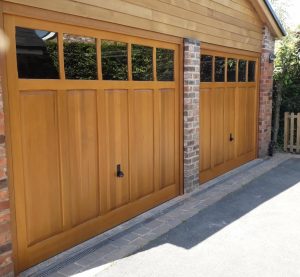 Woodrite Padbury solid cedar wood up and over garage doors in Light Oak finish with plain glazing