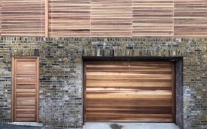J1: Cedar Door horizontally boarded timber sectional garage door ideal match to cedar fencing and side door.