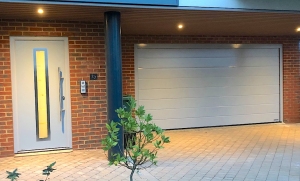 H1: Hormann LPU42 M-rib Silkgrain sectional door with matching TPS700 front entrance door in Window Grey