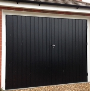 E: Fort side-hinged steel garage door set in standard vertical rib in Jet Black