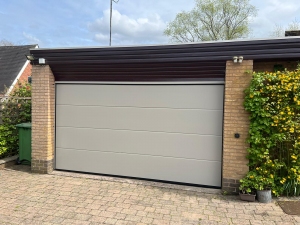 P1: Alutech large rib, smooth panel sectional door in RAL 7030 Stone Grey