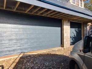 A: Wisniowski Unipro insulated sectional doors with a medium rib and woodgrain texture. Anthracite grey (RAL 7016)