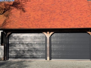 A2: Carteck Insulated sectional doors in centre rib woodgrain, colour Anthracite Grey