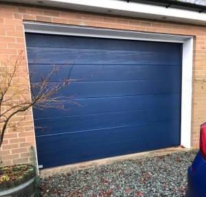 C: SWS sectional garage door in Navy Blue, Centre Rib in woodgrain