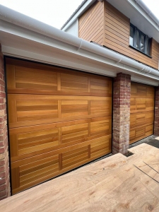 B2:Cedar Door Hassop sectional garage doors in Light Oak woodstain.