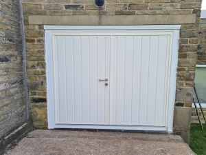 A: Carteck insulated side hinged door set, vertical rib, 50/50 split, in RAL 9001 cream, with woodgrain finish