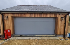 C2: Hormann LPU 42 large rib, silkgrain (smooth) insulated garage door in bespoke RAL 7045 Telegrey 1
